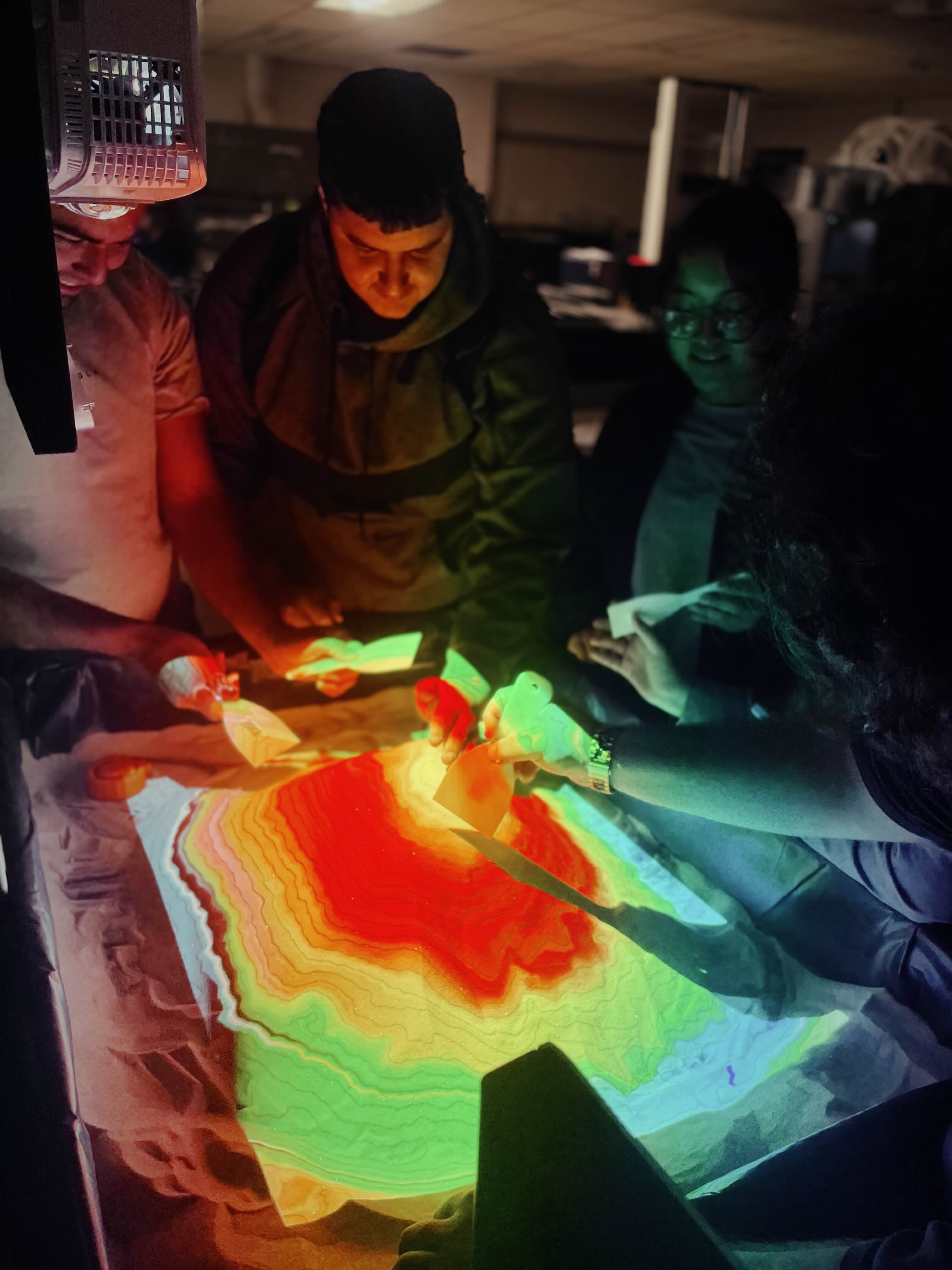 Picture of students interacting with sandbox.